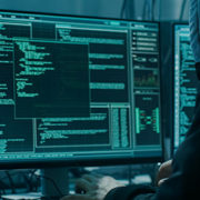 Hooded hacker on computer
