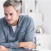 Man sitting at home looking at computer