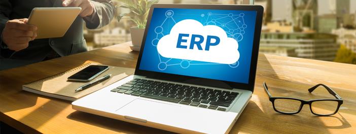 Computer on table showing "ERP" graphic